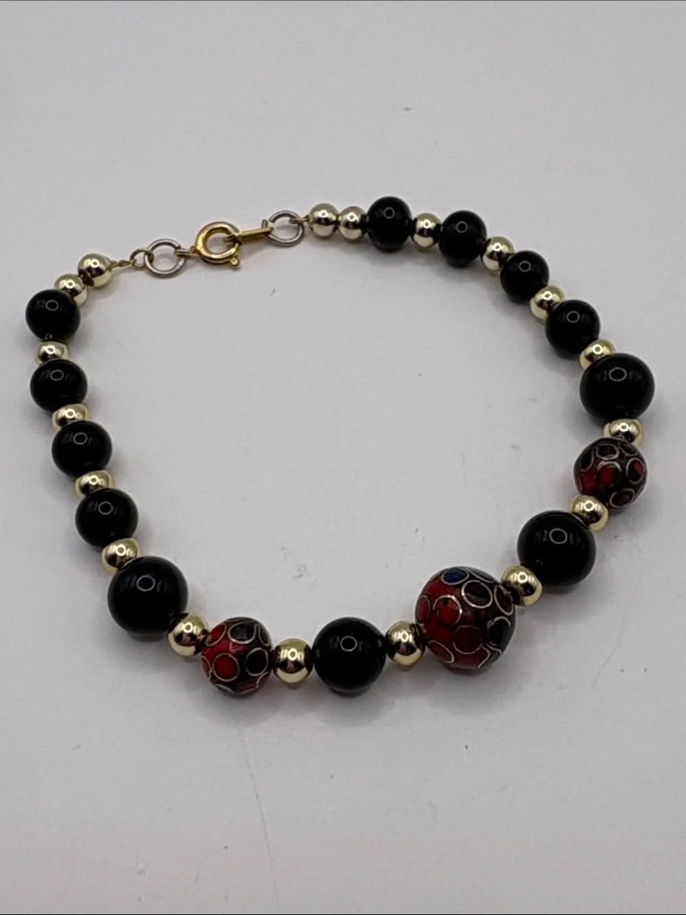 Gold Accent Black Bead Bracelet with Red Cloisonné Beads 7.5”